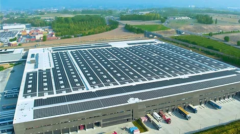 Vista aérea de nave industrial rehabilitada: nueva cubierta con placas solares como eje de eficiencia energética y sostenibilidad.